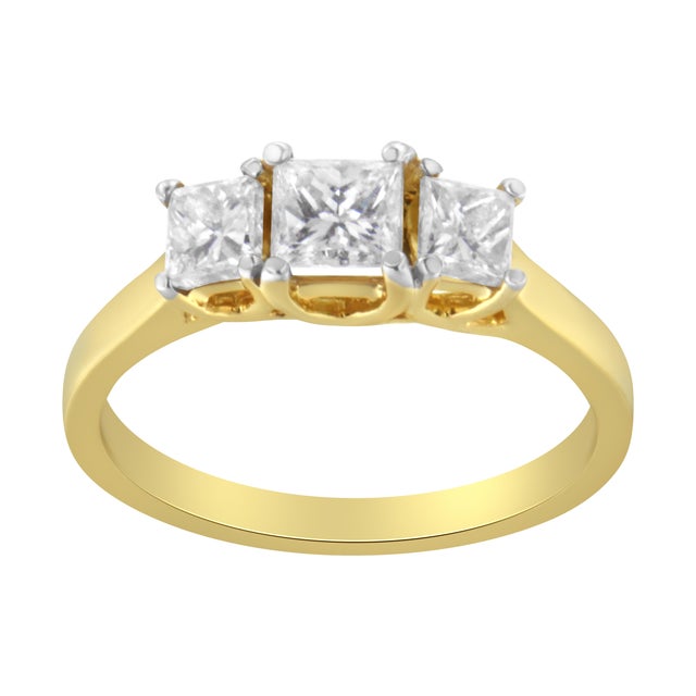 A three stone diamond ring that is delicately designed with three natural, sparkling princess-cut diamonds pring set in...