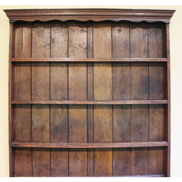 Circa 1860-80 Queen Anne style English Dresser. Oak of warm color. Raised on cabriole legs. Small central drawer over deep...
