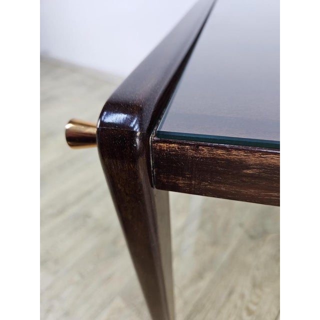 Mobile side table manufactured in France in the 1960s. The bar has two glass shelves and four handles, two on each side....