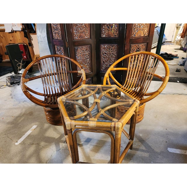 Rattan Boho Style Swivel Lounge Chairs and Matching Glass Topped Table, Circa 1970s Chairs have a natural finish rattan...