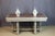 A painted wooden center table with a marble top. This table rests on six legs joined by a stretcher. Late 19th century....