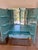Jonathan Adler Delphine Bar in brass and mirror. Antiqued mirrored exterior with polished brass base; double doors open to...