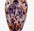 This is a classic tall Imari vase that dates to the Meiji period. It is beautifully decorated with a wisteria reserve to...