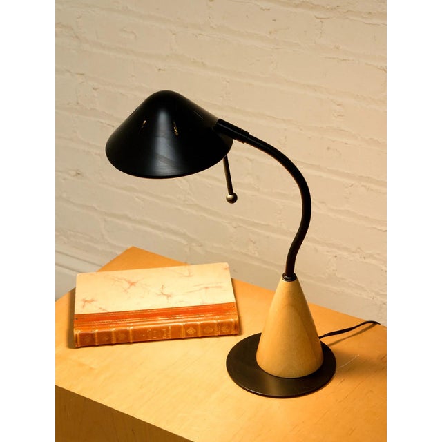 A fantastic vintage desk lamp with a playful geometric silhouette combining a warm wood cone base with a dramatically...