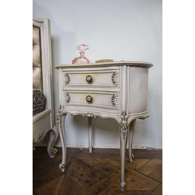 White bedside tables in the Louis XV style with decorative knobs in the Louis XVI style decorated with a gallant scene....
