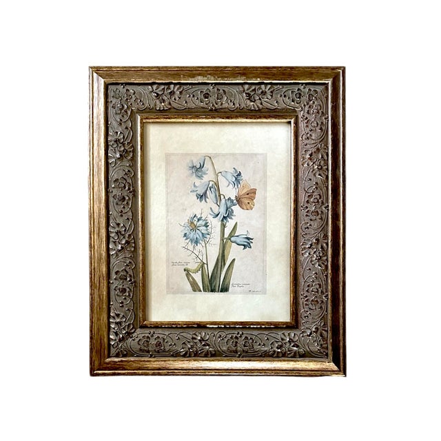 A charming set of vintage framed botanicals. Each features a beautiful, floral print framed in a carved floral frame with...