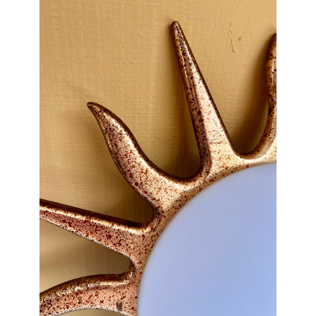 Vintage sunburst wall lamp by Dutch lighting manufacturer Steinhauer. Gold-coloured metal frame with a speckled finish and...