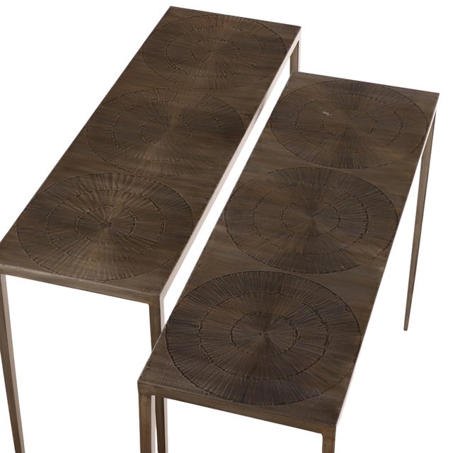 Elegant pair of iron console tables featuring a bronze-wash finish and distinctive circular design elements. The...