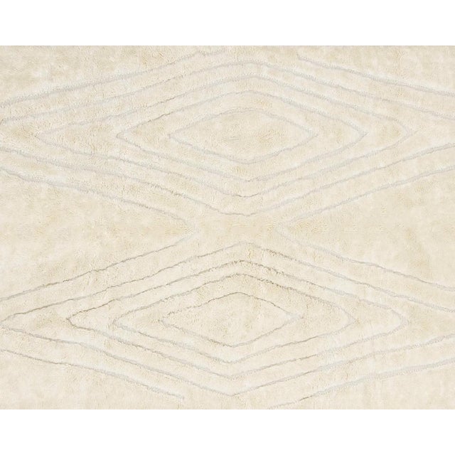 Elegant hand-knotted natural wool rug, featuring symmetrical diamond patterns. An ideal choice for anyone looking to...