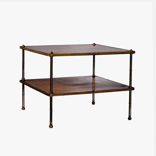 Beacon Hill two tiered side table. Brass with mahogany veneer shelves. Mahogany veneer has distressed areas with surface...