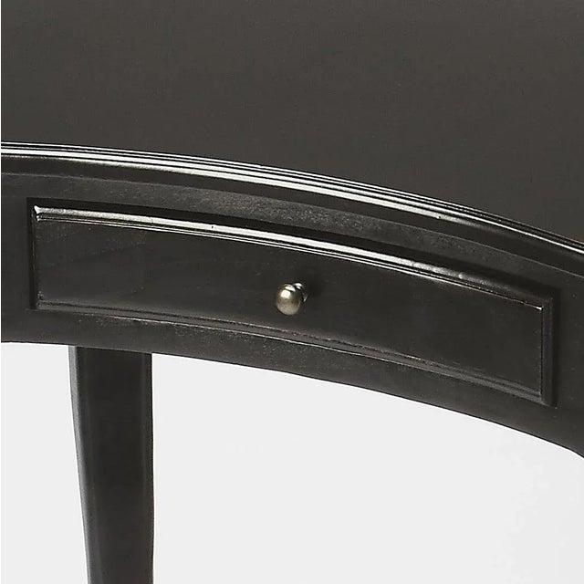 This elegant Writing Desk features a crescent shape tabletop supported by four stylized, tapered cabriole legs and a...