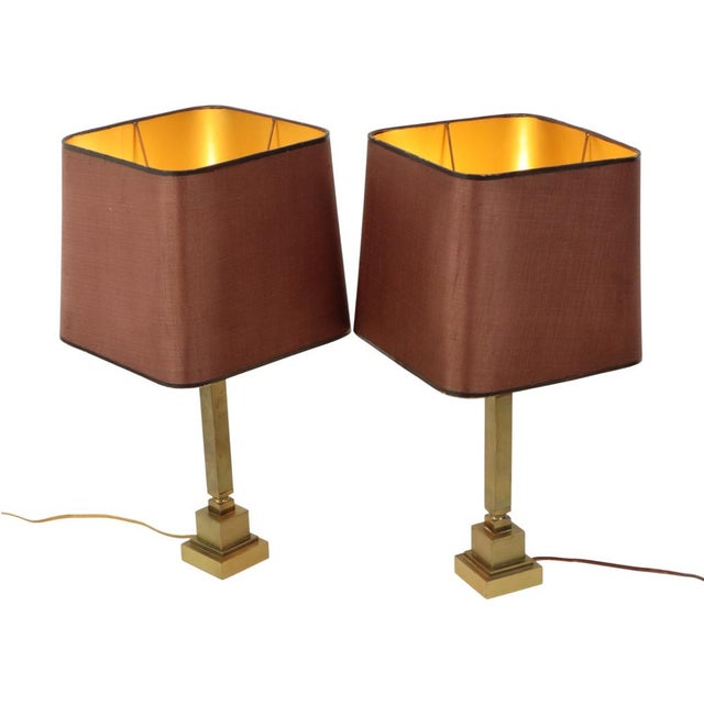 Pair high-quality mid-century design brass table lamps with their original burgundy-colored square lampshades with a gold...