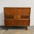 A substantial Danish teak highboard designed by Johannes Andersen, combining generous storage with a thoughtfully...