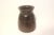 Carved wood vessel with chippy edges and a repair with a staple and filler to fix a natural crack in the wood. The base is...