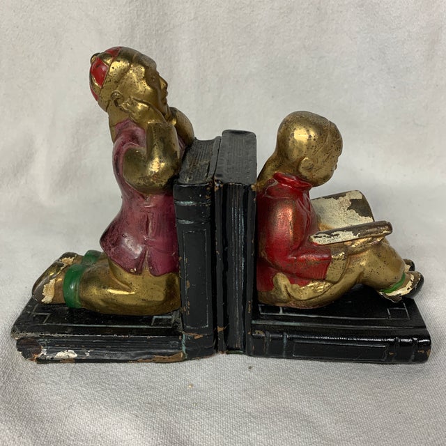 This vintage pair of Art Deco bookends features children reading and kneeling, crafted by makers like Armor Bronze Co.