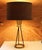 Small table lamp with 3 wrought Iron rods on a solid brass ring, tapered to a small ring that flares out to hold light...