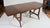 This Heywood Wakefield mid-century maple dining table features a distinct drop-leaf design with a rich brown finish. A mid...