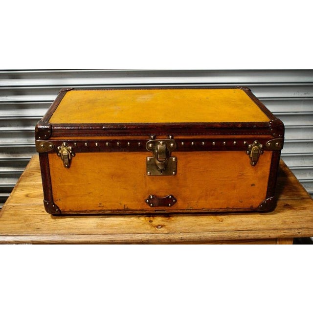 A superb louis vuitton steamer trunk dating to circa 1910, covered in the distinctive orange vuittonite canvas and...