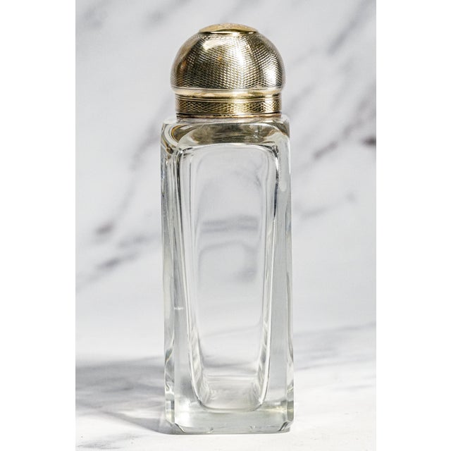 An exceptional example of late Victorian craftsmanship, this antique crystal scent bottle combines luxurious materials...