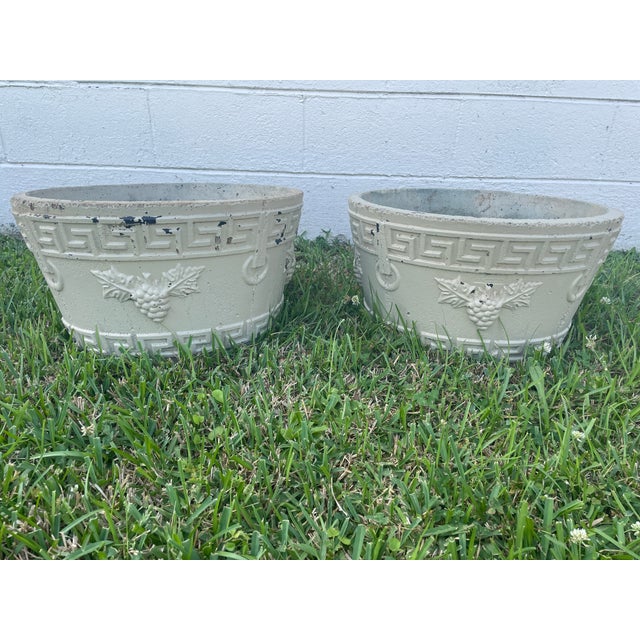 A substantial and highly decorative pair of mid-century cast stone tub planters, sourced from a historic Asheville, North...