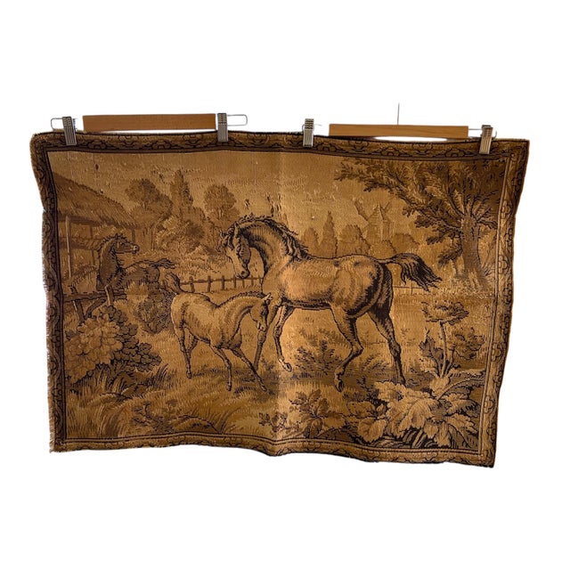 This vintage woven tapestry depicts a pastoral horse scene with intricate detail. The composition features a mare and foal...