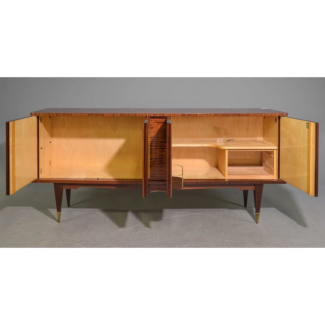 This exceptional French Mid-Century Modern sideboard combines sophisticated design with outstanding functionality. Crafted...