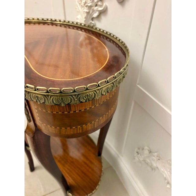 A fine antique french louis xv style kidney-shaped occasional table of elegant, refined form. The shaped top is...