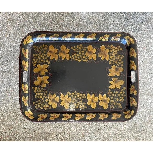 This stylish tole ware tray on stand will make a beautiful statement with its simple form and use of materials. The tray...