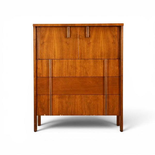 This 1960s John Widdicomb highboy dresser is a refined example of the clean, architectural cabinetry that made the Grand...
