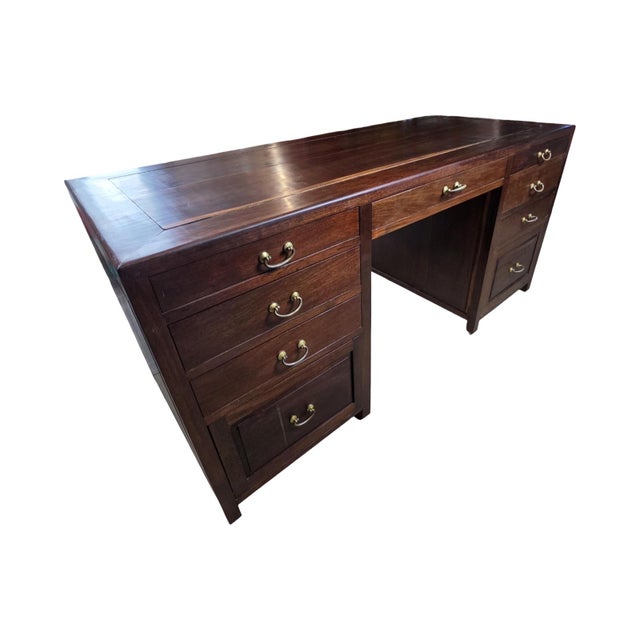 Handsome vintage executive desk featuring a rich dark wood finish, warm brass-tone hardware, and distinctive Asian-...