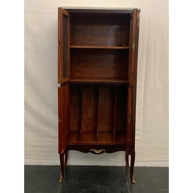 Napoleon III-style storage cabinet with cherry, walnut, and beech veneers, featuring gilded bronze accents. Gray-veined...