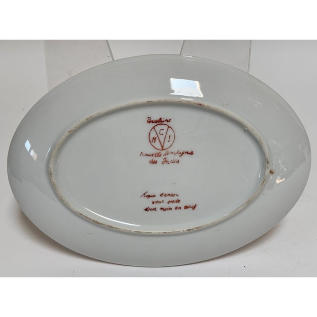 Nouvelle Compagnie des Indes Apponyi Purple Porcelain Serving Dish, Hand-Painted, Mid-20th Century An elegant oval...