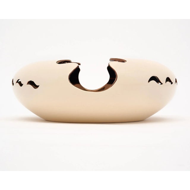 Ceramic vase / bowl from France with a cream glaze exterior and gold interior. We were drawn to the unique design –...