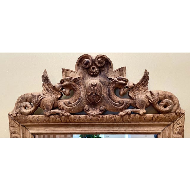 Extraordinary one-of-a-kind, handcrafted, large (and heavy) solid wood wall mirror featuring bold chimeric forms atop the...