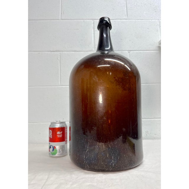 Up for sale is a large antique early 19th century hand blown glass demijohn wine bottle. It's blown by hand out of thick...