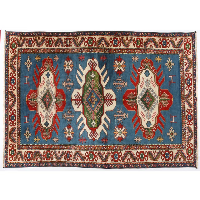 A striking modern-design rug showcasing a beautifully balanced color palette of saturated sky blue, crisp ivory, rich red,...