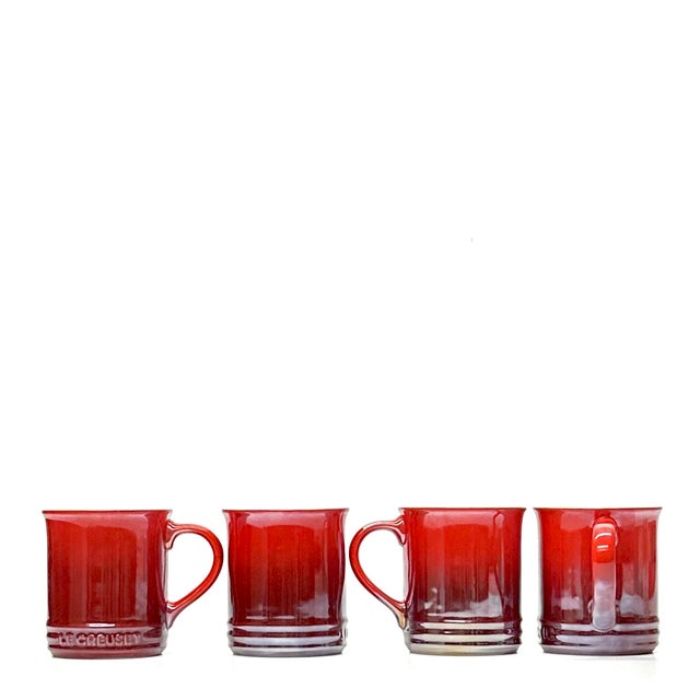Cerise red mugs, group of 4. A beautiful set of limited edition Le Creuset 14 oz. Stoneware Mugs in a Pearlized Cerise...