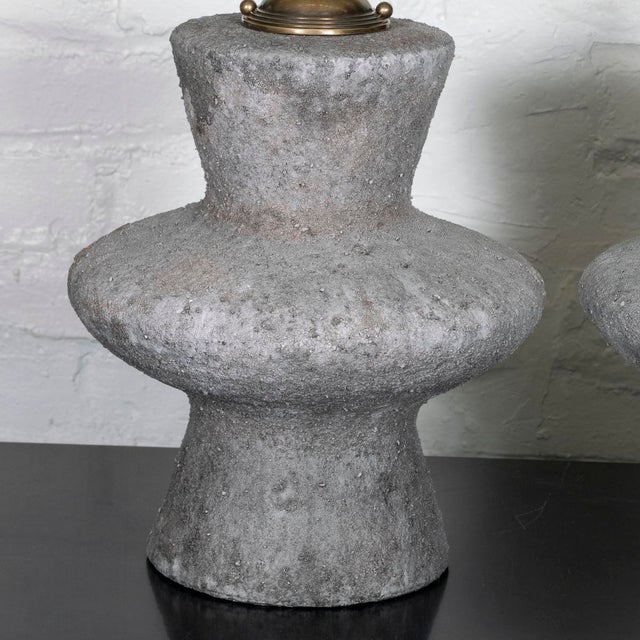 Pair of gray ceramic table lamps with concrete-like distressed finish.