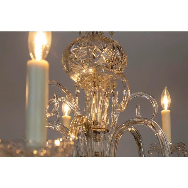 A Georgian style chandelier with waterfall oriented crystals on the top and bottom, intricately cut crystal bowls and...