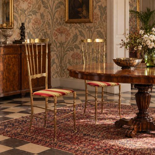 Pair of high-back chairs made in Italy in the 1950s, featuring an elegant brass frame. The seats are upholstered with the...