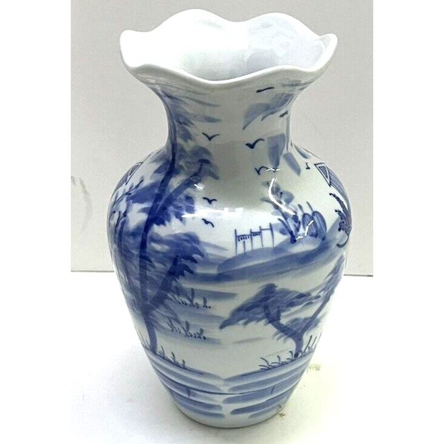 Elegant vintage Chinese blue and white porcelain vase featuring a beautifully detailed traditional scenic design. The...