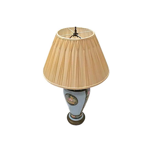 Antique hand-painted porcelain floral lamp with a central medallion of a floral basket and a top and bottom band of floral...