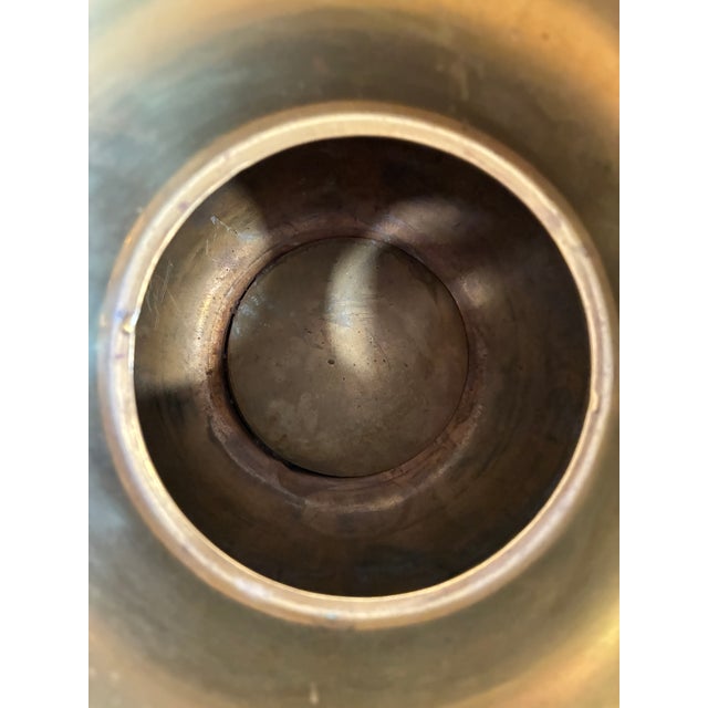A striking vintage brass spittoon featuring an embossed Pony Express Chewing Tobacco advertisement with a detailed rider-...