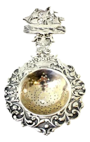 Silver Tea Strainer with Reliefs, Applications and Caravel Cut-Out Handle