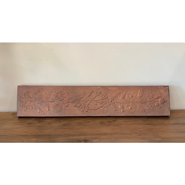 Lovely vintage 1970s copper relief wall panel depicting a classic floral and ribbon motif. Made of solid wood and covered...