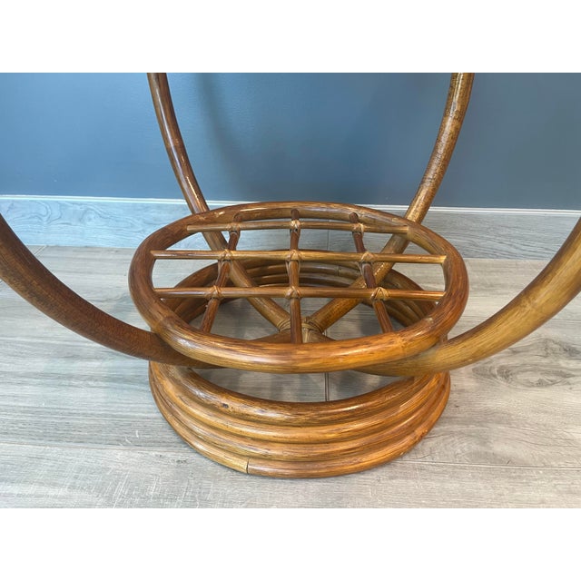 Stylish vintage MCM round side table with clear glass top. Bamboo base, perfect for adding a bohemian or Tiki vibe to your...