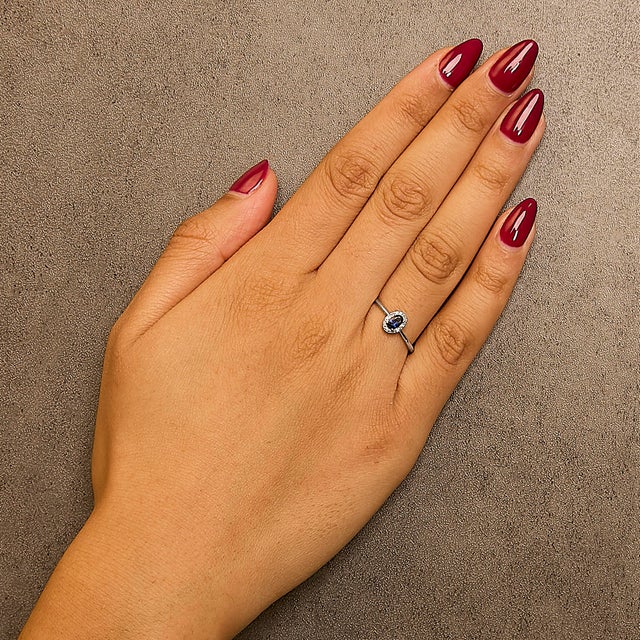 Elegant and radiant, this exquisite ring is a symphony of color and light, masterfully crafted from rhodium-plated 10K...