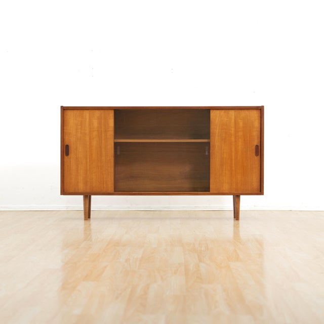 This Mid Century cabinet was produced in England during the 1960s. A wonderful design and excellent storage piece. Made...