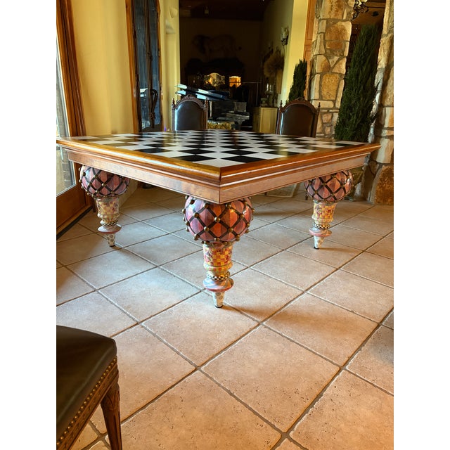 Exceptional MacKenzie-Childs Train dining table featuring an oversized square checkerboard top and four spectacular...