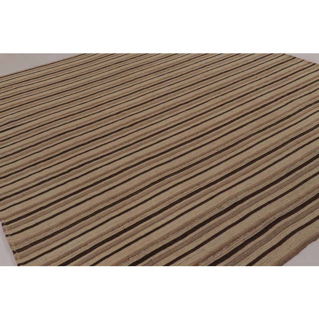 Made with handwoven wool circa 1950-1960, this 10x10 vintage square flat-weave Kilim is a particularly substantial and...